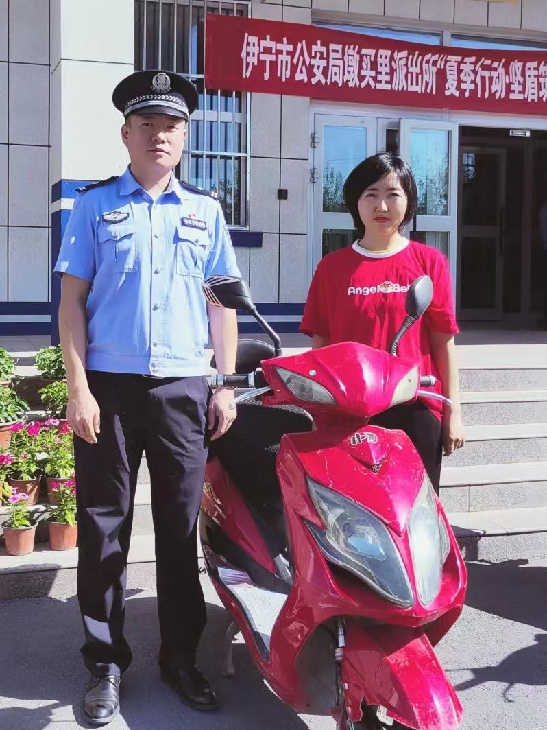 图说：民警刘波给失主王女士退还丢失的摩托车.jpg