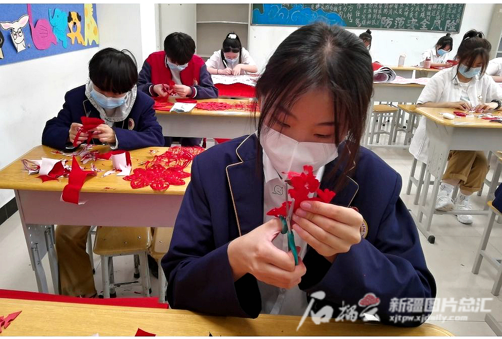 学生们在课堂上学练剪纸。兵团第十二师职业技术学校供图
